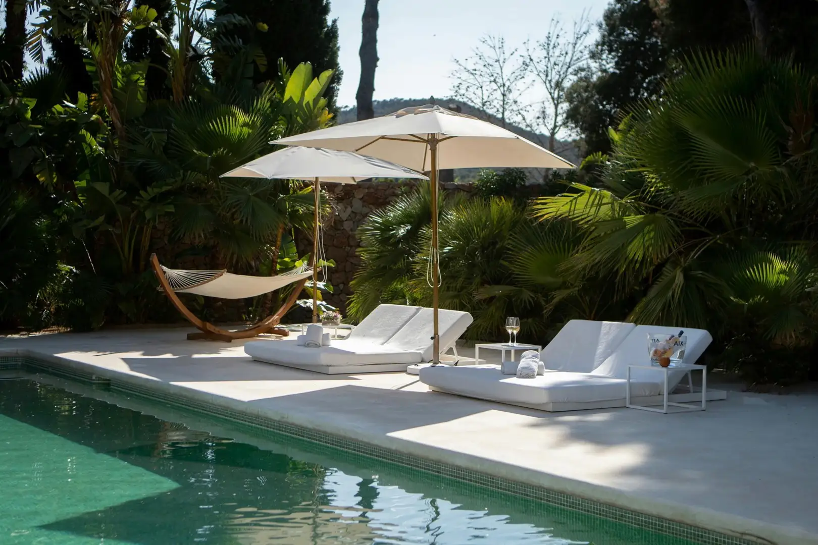 Poolside view of Villa Aria in Ibiza, showcasing the comfort and privacy of a luxury villa vs 5 star hotel stay.