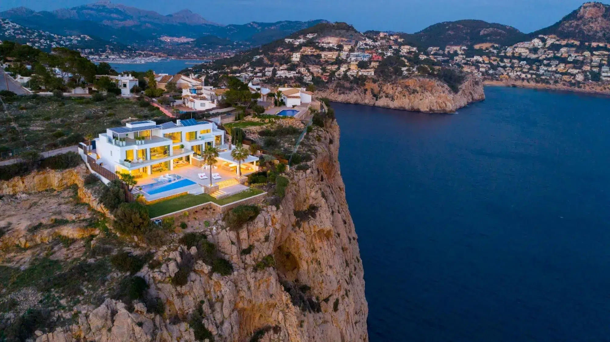Luxury cliffside villa in Port Andratx overlooking the sparkling Mediterranean Sea, with panoramic ocean views and elegant architecture.