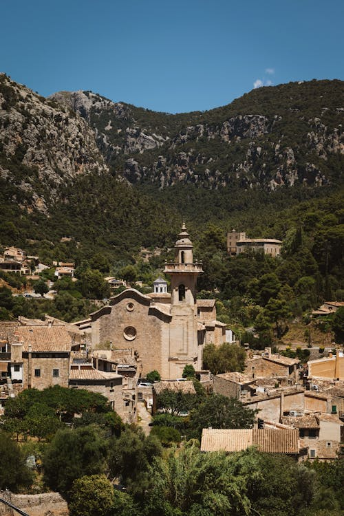 Historic town of Valldemossa in Mallorca, famous for its monastery, surrounded by mountains and greenery.