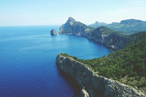Landscape of Cap de Formentor in Mallorca with dramatic cliffs, Mediterranean forest, and sustainable travel destination views over the Balearic Sea.