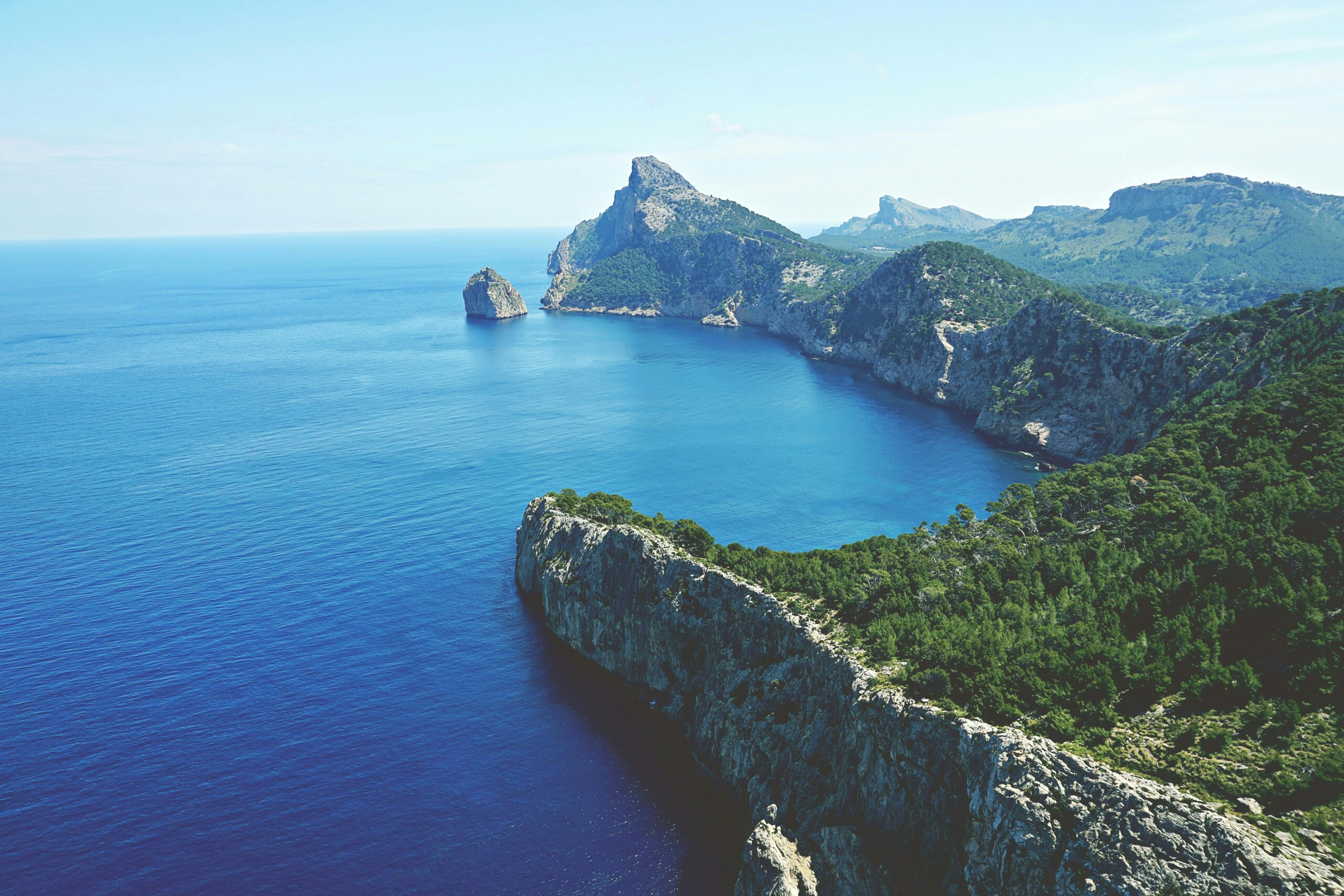 Landscape of Cap de Formentor in Mallorca with dramatic cliffs, Mediterranean forest, and sustainable travel destination views over the Balearic Sea.
