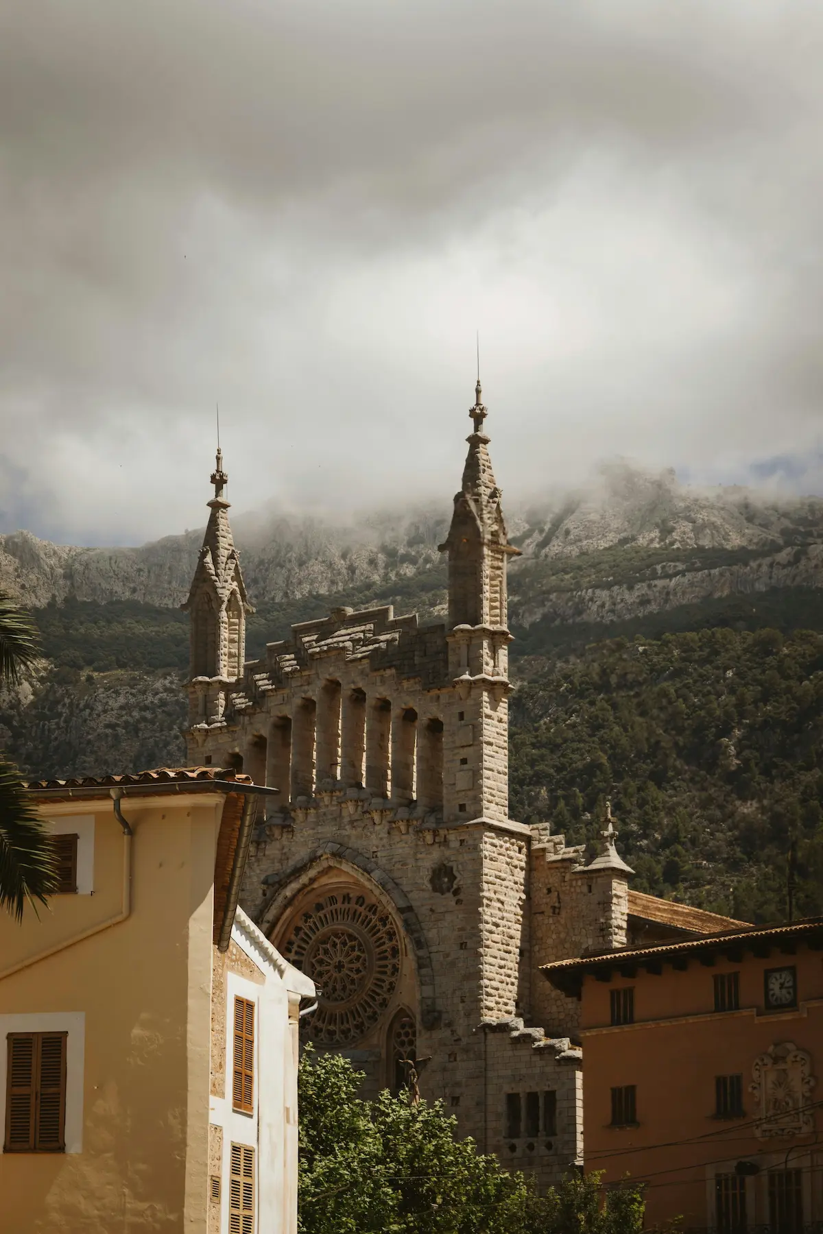 Church of Saint Bartholomew in Sóller Mallorca, a neo-Gothic landmark designed by Joan Rubió i Bellver, framed by the Tramuntana mountains