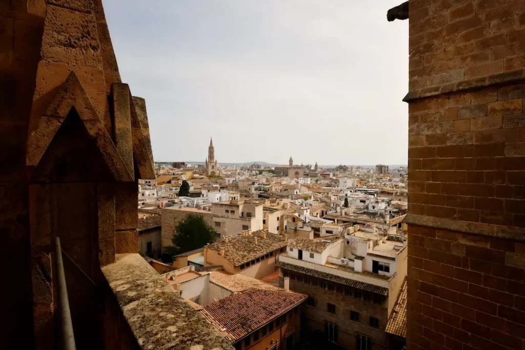 Panoramic view of Palma de Mallorca city with historic rooftops and cathedral spires, representing Mallorca’s luxury tourism and urban landscape.