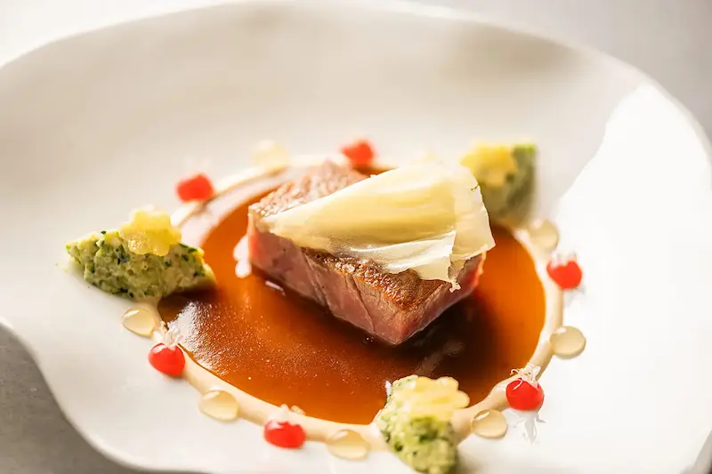 Refined Mediterranean dish served at Andreu Genestra restaurant in Llucmajor, Mallorca, showcasing contemporary fine dining with local ingredients.